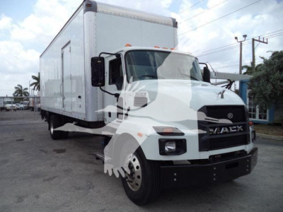 Box truck with white cab and large cargo box, Mack grille, front view slightly angled, logo visible, parking lot background.