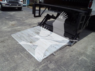 Truck with folded aluminum liftgate in lowered position showing platform and hydraulic arm assembly; Mack MD7 equipment context implied by listing.