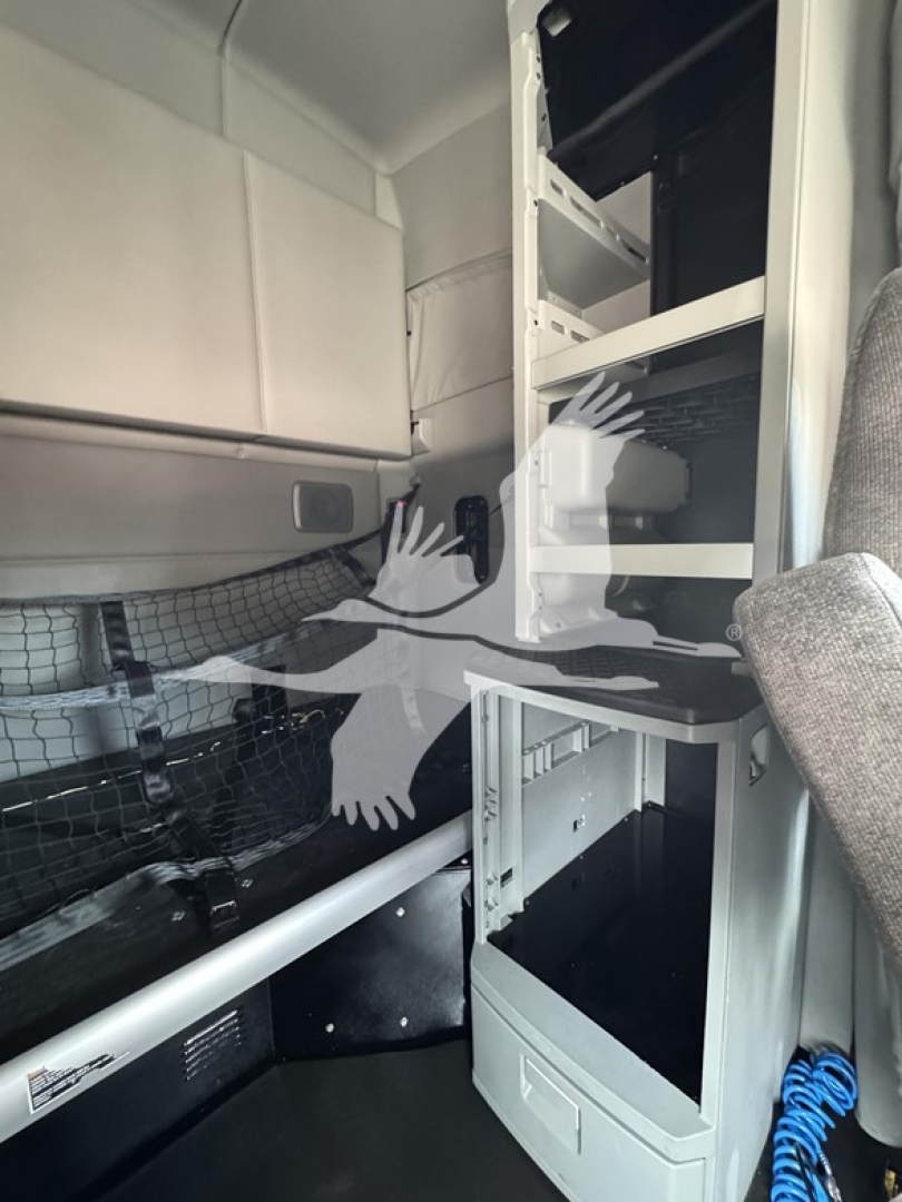 Kenworth T680 truck cab interior showing storage shelves and ladder area