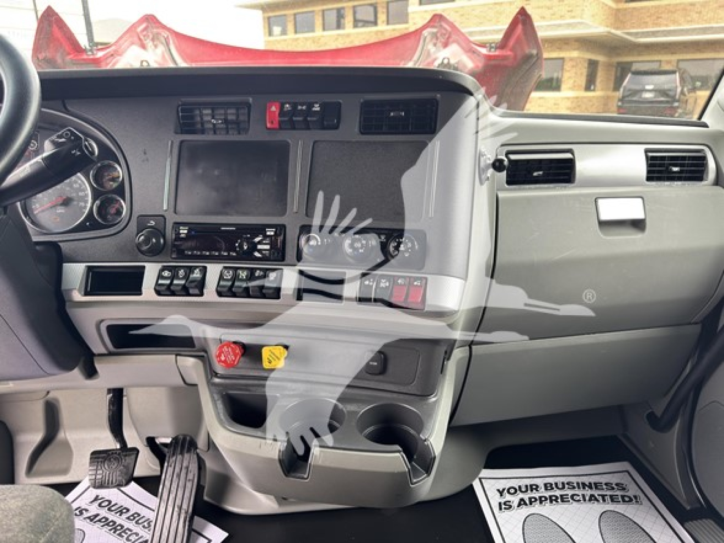 Kenworth T680 dashboard and center console view showing gauges, touchscreen display, and control panels.