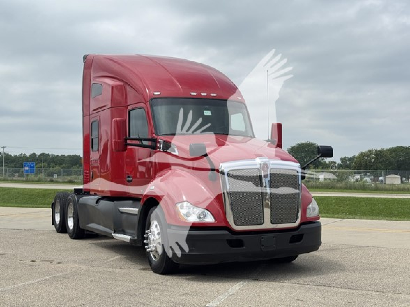 Kenworth T680 class-8 truck in red cab, front three-quarter view, with chrome grille and dual rear axles; no visible text on the image.