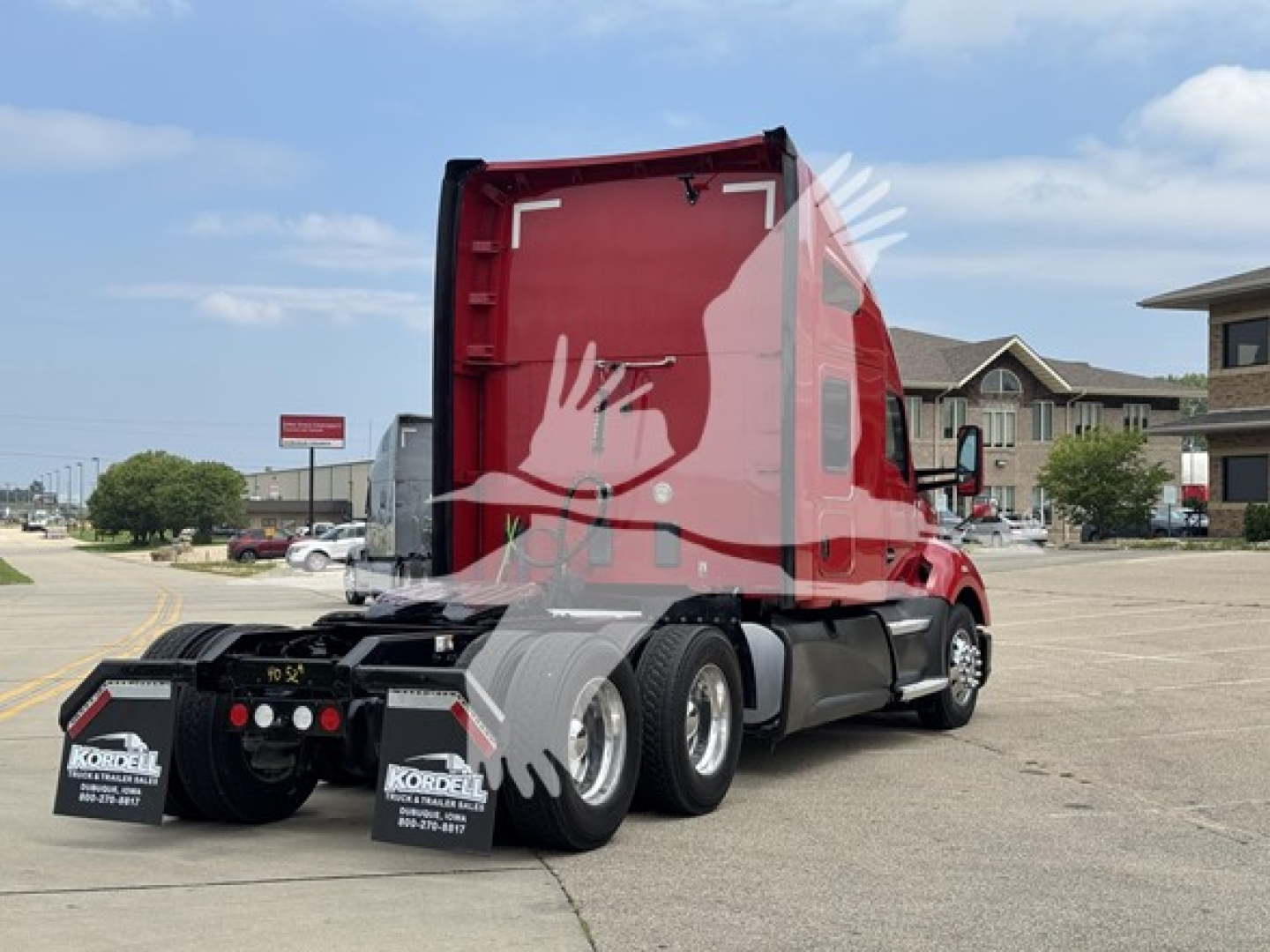 Kenworth T680 sleeper tractor truck rear view showing red cab and dual rear axles with mud flaps and license plate area
