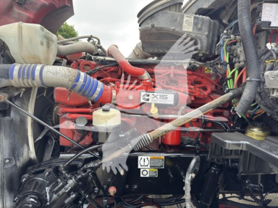Kenworth engine bay showing X15 diesel engine label and surrounding components.