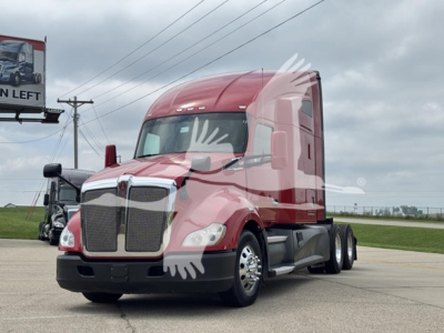 Kenworth T680 conventional sleeper truck in a red color profile view showing front grille, headlights, and side mirrors.