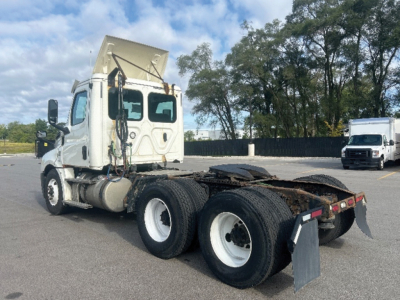 Truck chassis and cab of a Freightliner Cascadia 126 with dual rear axles and a fifth-wheel plate.