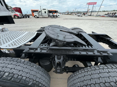 Kenworth T680 chassis with fifth wheel and dual rear axles, view from rear-right side showing fifth wheel, frame, and tires.
