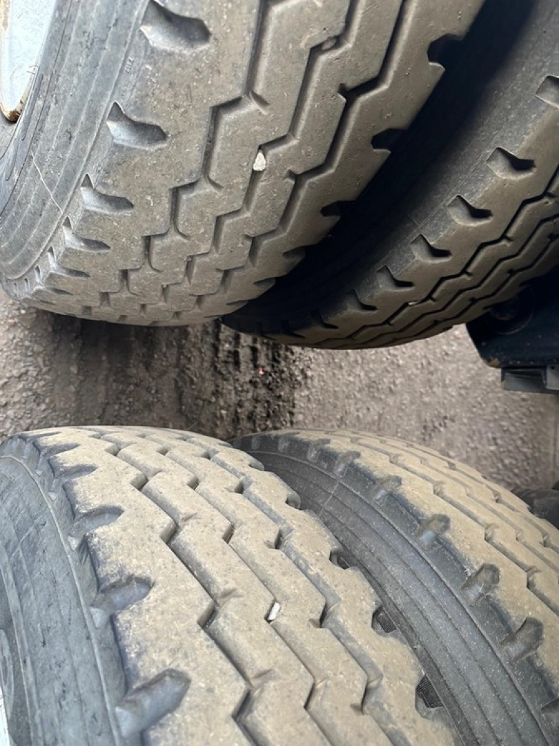 Rear tires of a dump trailer with tread pattern visible; image shows dual tires on a Jet Air Ride Side Dump trailer.