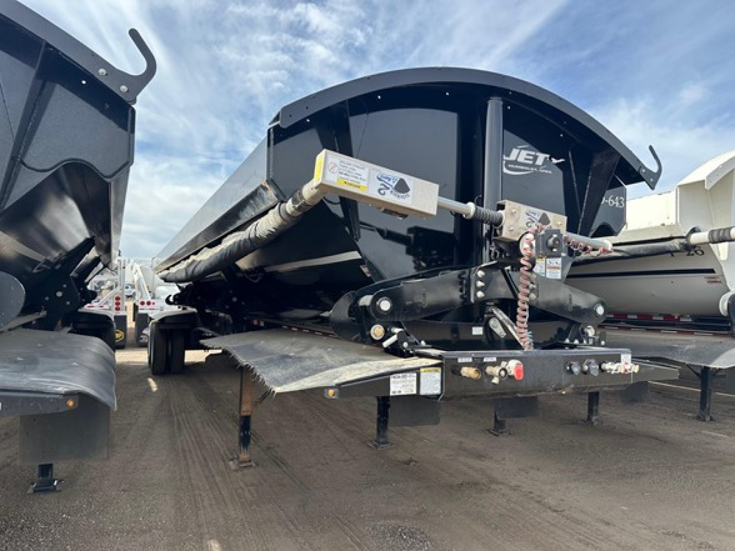 Jet Air Ride Side Dump trailer showing hydraulic tilt mechanism and deck with support legs.