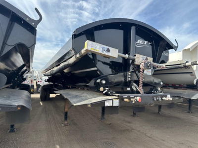 Jet Air Ride Side Dump trailer showing hydraulic tilt mechanism and deck with support legs.