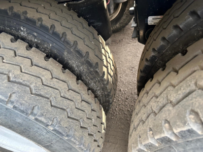 Twin front truck tires with deep tread on a Jet Side Dump trailer showing rugged tire patterns.