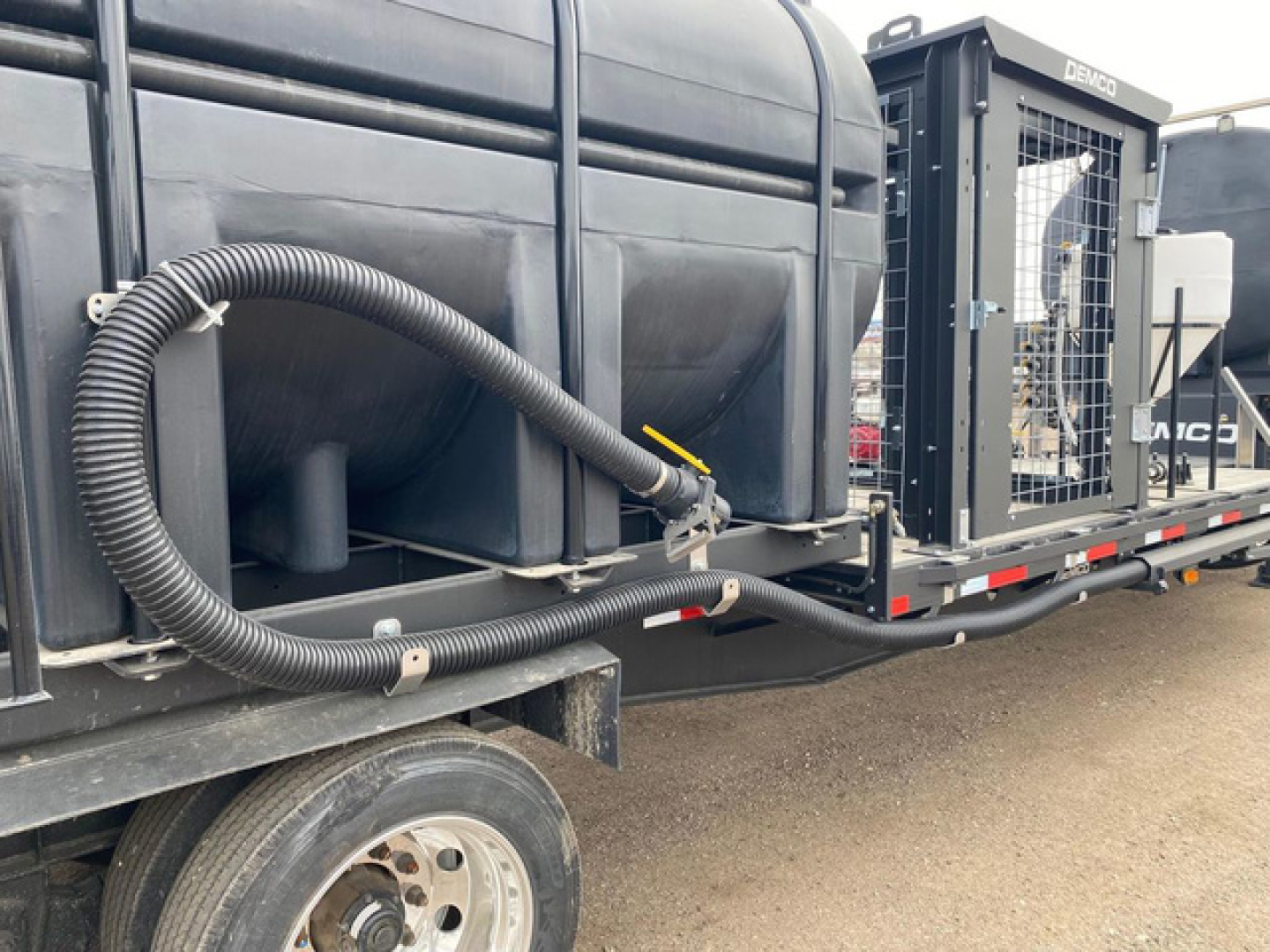Demco Liquid Tender trailer with side tank and hose, VIN 007235, stock N87063, new condition.