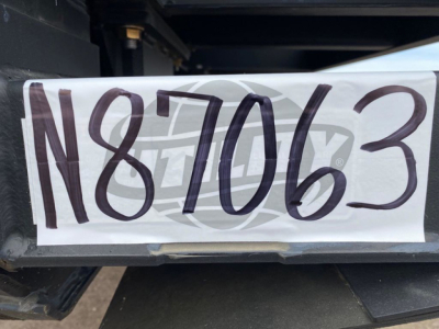 Trailer nameplate with large stock number N87063 mounted on Demco Liquid Tender trailer hitch area.