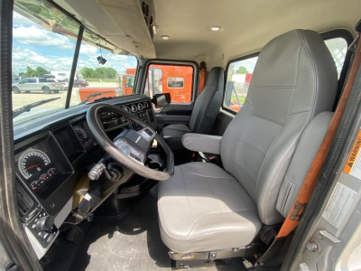 Cab interior of a 2019 Mack PI64T conventional daycab showing steering wheel, driver's seat, dashboard, and controls.