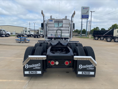 Rear view of a 2019 Mack PI64T conventional daycab truck showing dual rear axles, mud flaps labeled ENID and Bruckner's Truck Equipment, and a metal Freight-style sleeper with a protective grille.