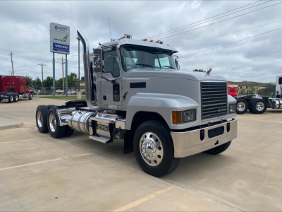 2019 Mack PI64T truck with cab and chassis in a dealership lot, front grille visible, with fuel tanks and dual rear axles.