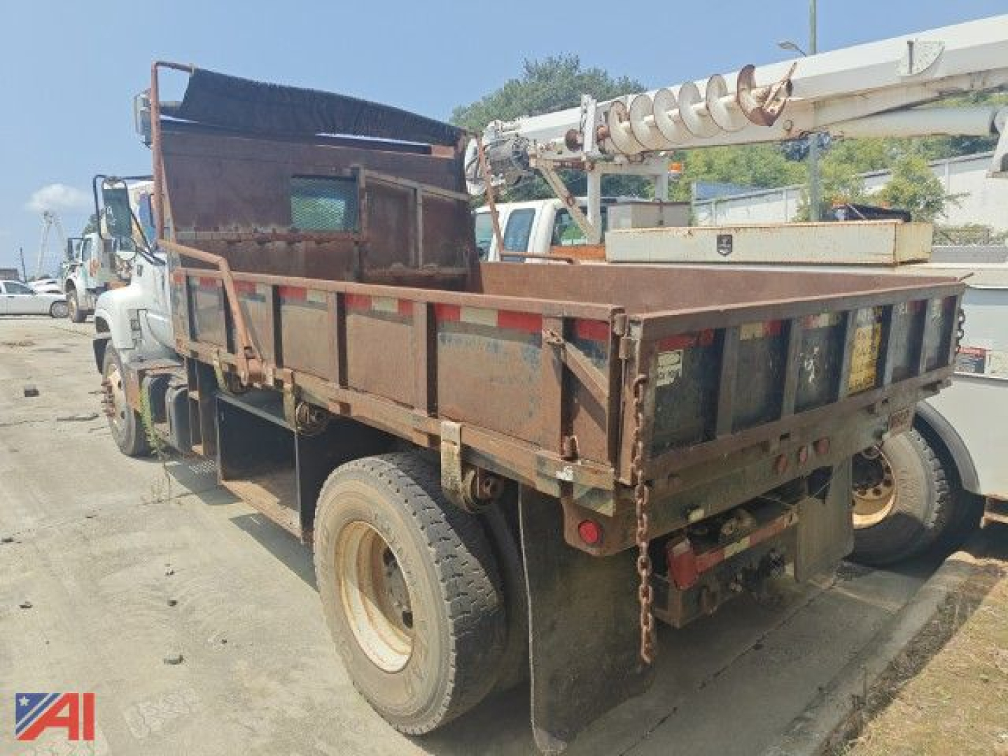 Dump truck bed and rear view of a 2000 Chevrolet C7500 dump truck in service showing truck bed, taillights, and storage box.
