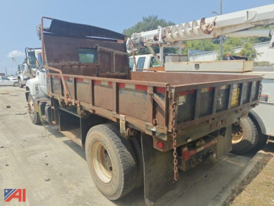 Dump truck bed and rear view of a 2000 Chevrolet C7500 dump truck in service showing truck bed, taillights, and storage box.