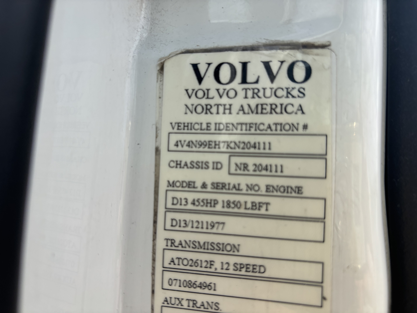 Volvo Trucks identification plate showing VIN, chassis ID, model & serial, engine, and transmission details.