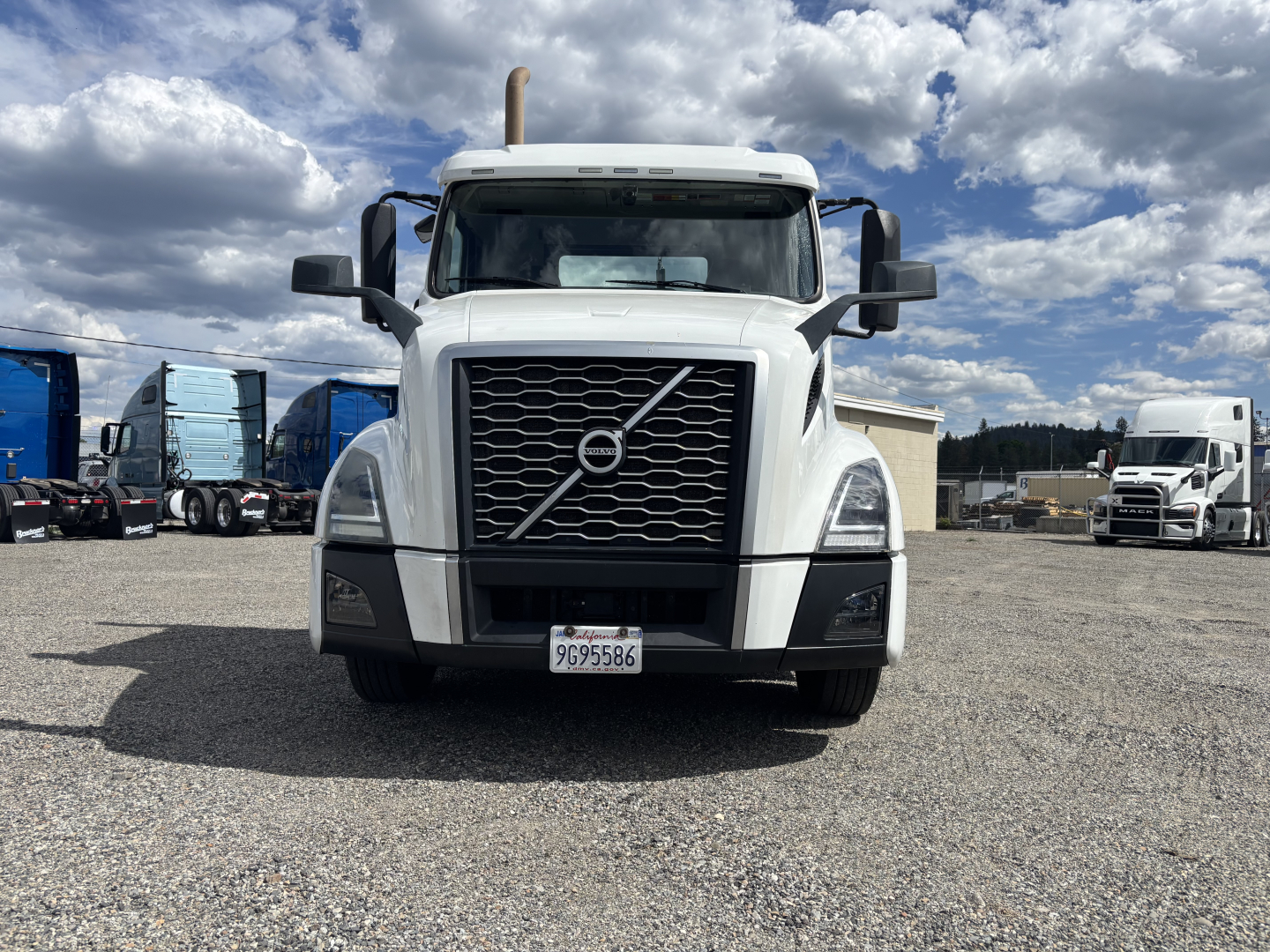 2019 Volvo VNL84T300 conventional daycab truck front view with Volvo emblem grille and license plate in yard.
