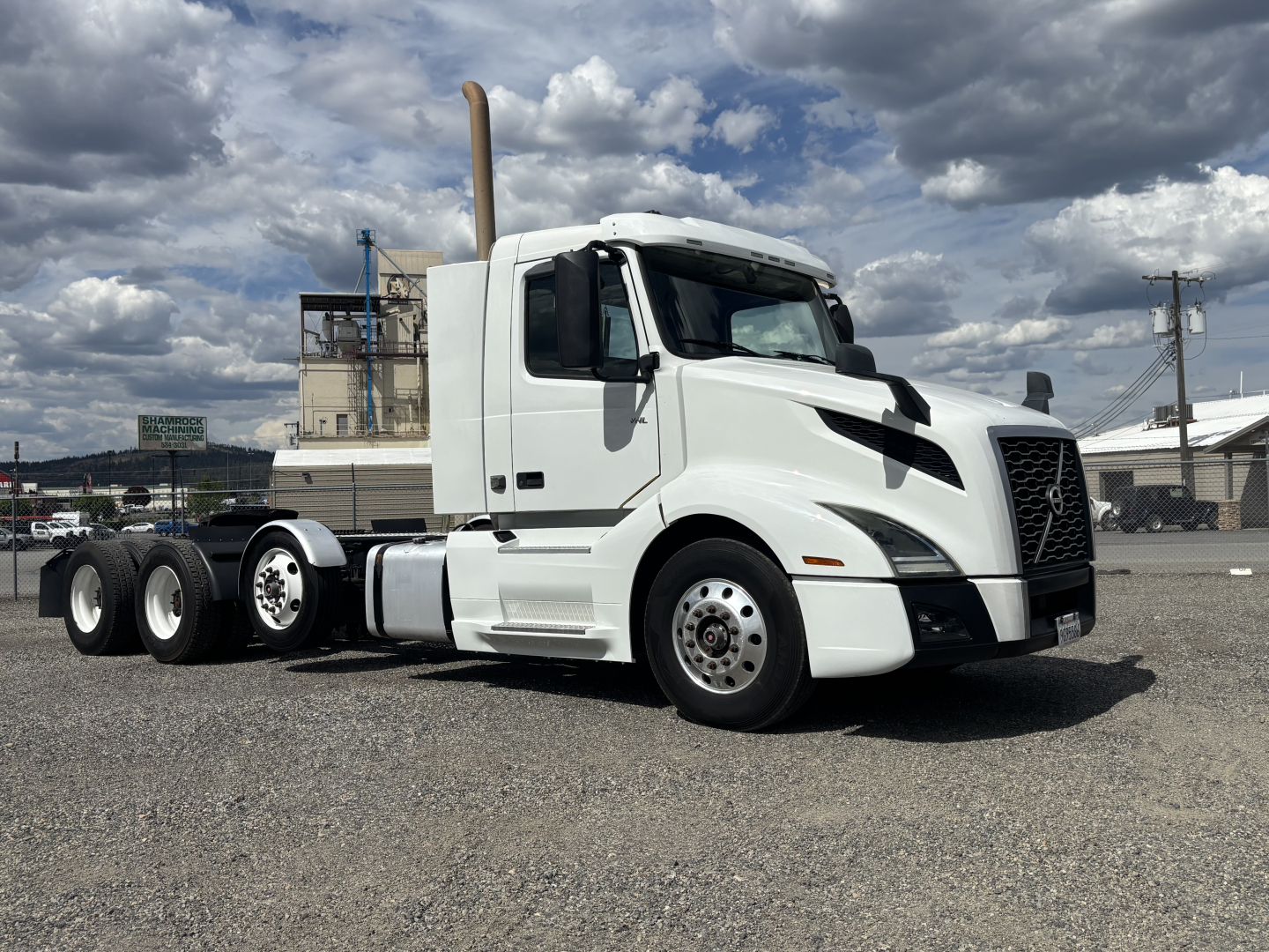 2019 Volvo VNL84T300 conventional daycab tractor shown in white, three-axle rear, side view with exhaust stack and Volvo grille, no visible damage.