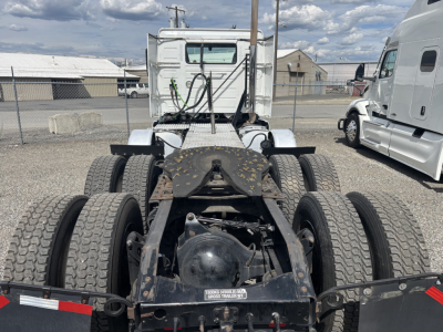 Truck chassis rear view showing dual rear axles, fifth wheel area, and back of cab on a used 2019 Volvo VNL84T300 with visible tires and suspension components.
