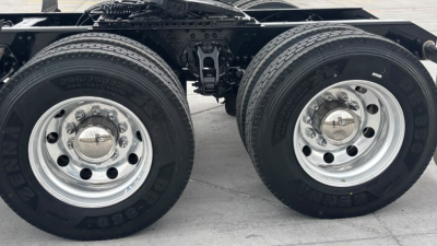 Kenworth T680 chassis with dual rear axles, two wheels visible, chrome hubcaps, tires labeled Goodyear, no visible damage.