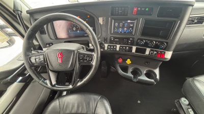 Kenworth T680 interior dashboard view showing steering wheel, infotainment screen, and controls.