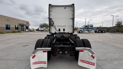 Kenworth T680 rear view showing fifth wheel assembly and dual rear axles with Kenworth mud flaps.