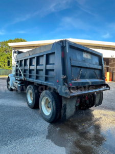 Kenworth T370 dump truck rear and side view showing dump bed and dual rear wheels.