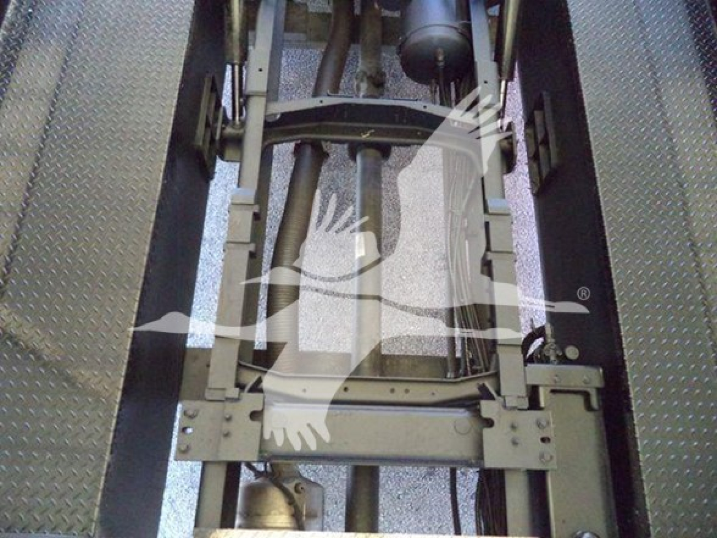 MD6 truck chassis view showing structural frame and hydraulic components in the engine bay area.