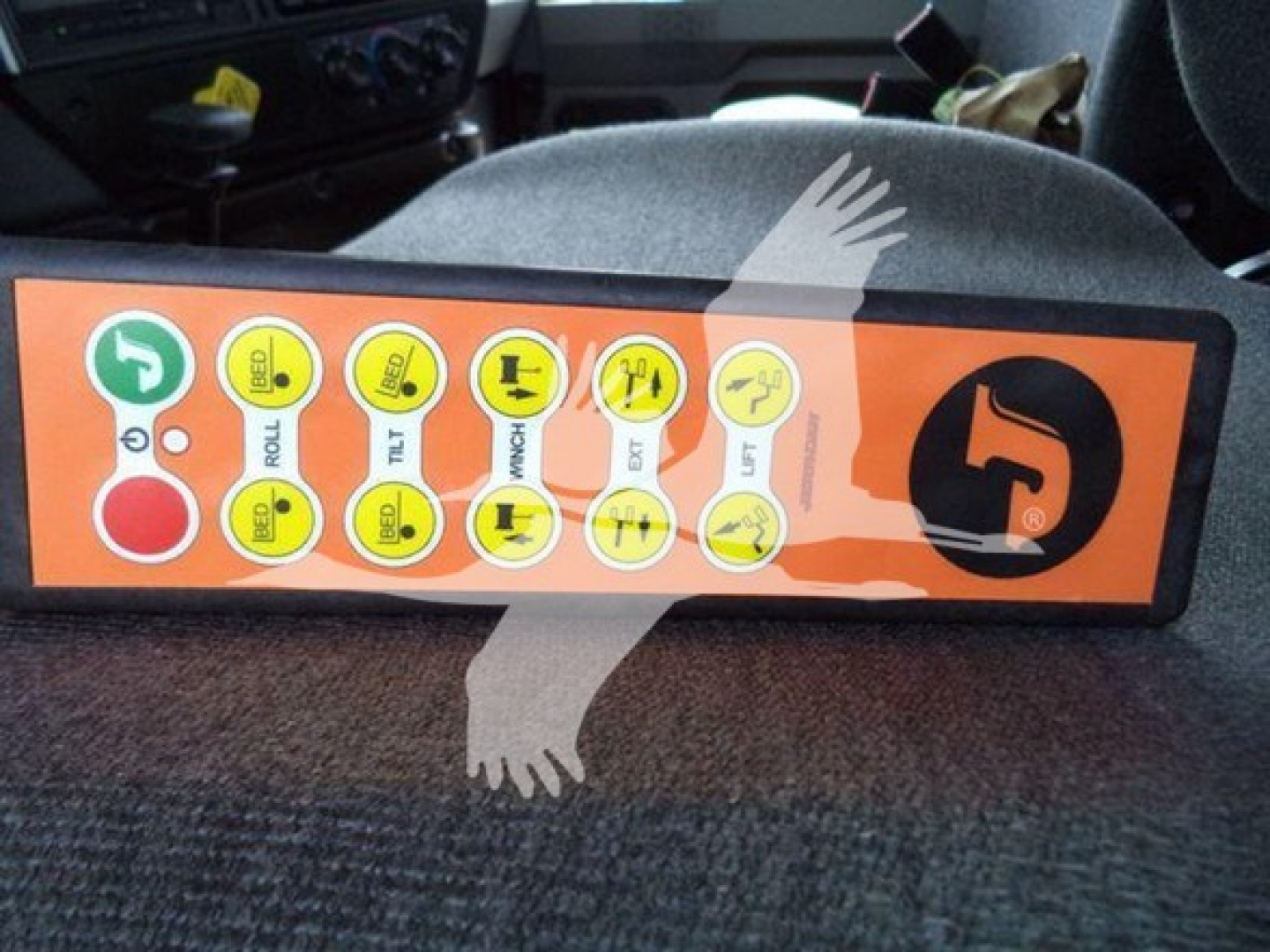 Dashboard control panel with multiple circular icons and green start/green indicators, orange background. Brand logo on right. Text on circles includes labels like ROLL, TILT, etc.