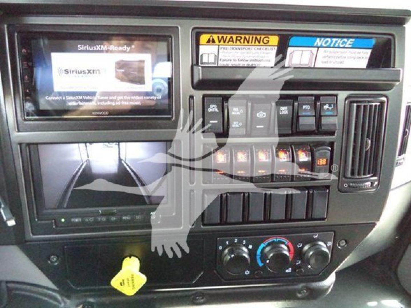 Mack MD6 dashboard view showing SiriusXM Ready display and control panel with warning labels and climate controls.