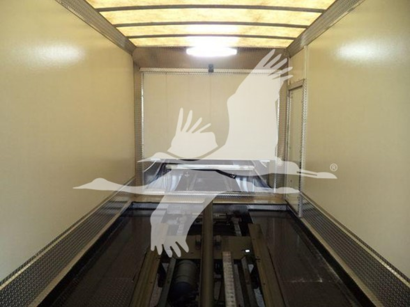 Mack MD6 truck rollback interior trailer with empty load area. No legible text visible inside image.