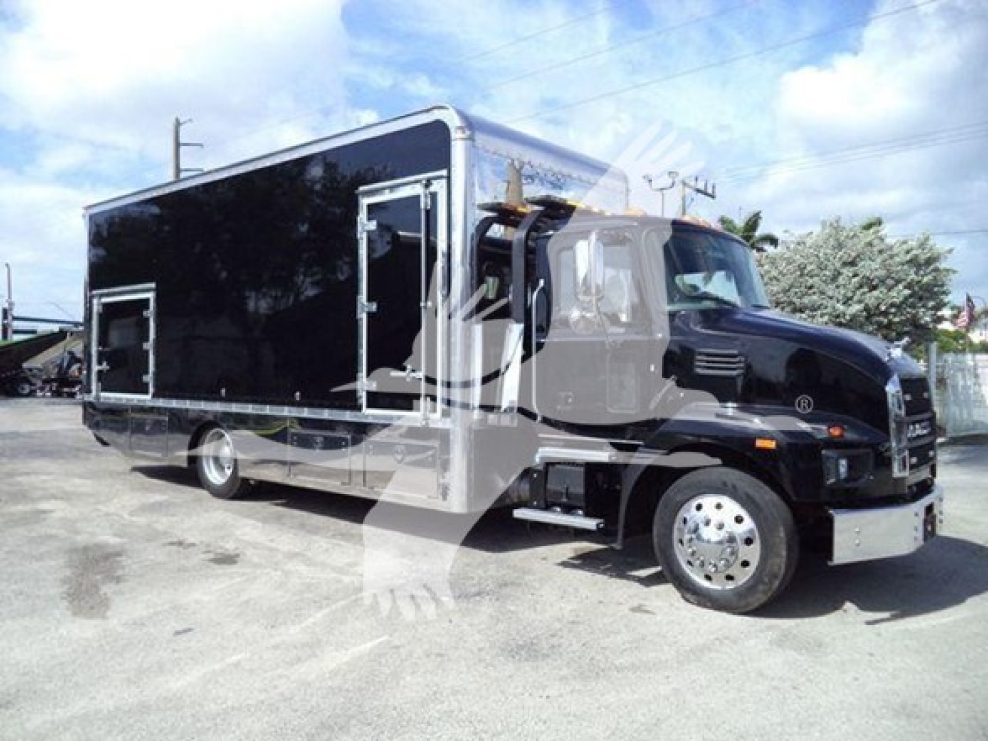 Mack MD6 rollback truck shown in side view with black cargo box and front grille details.