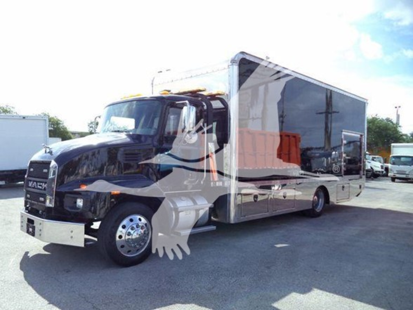 MD6 dump truck with a large black cab and a long silver/gray module body, side view showing chrome wheels and side mirrors.