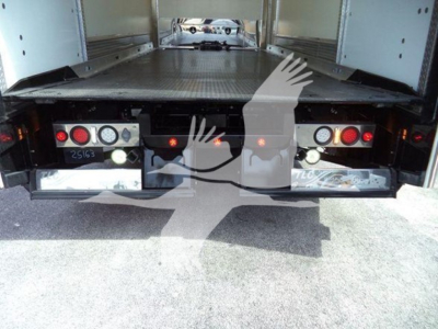 Rear view of a 2022 Mack MD6 rollback truck showing taillights and platform.