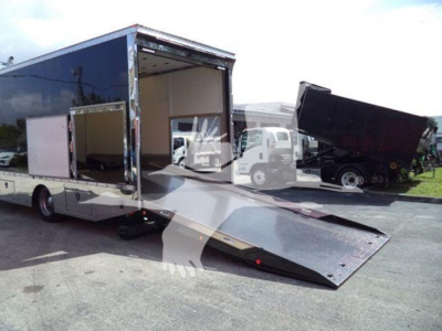 Back view of 2022 Mack MD6 rollback truck with a side ramp extended, opened cargo area showing interior.
