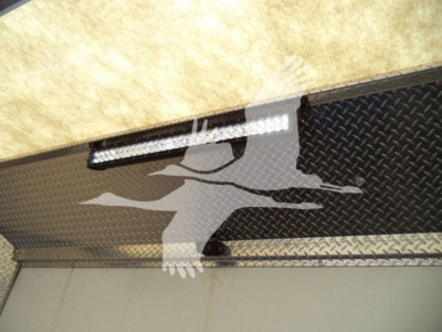 Mack MD6 truck bed or side panel with diamond plate texture and a slim LED light bar mounted above a metal surface.
