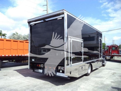 Mack MD6 roll-back truck trailer rear and side view with reflective black panels, chrome trim, and multiple access doors.