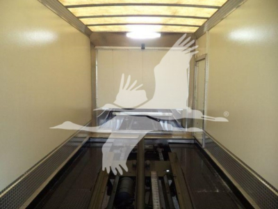 Mack MD6 truck rollback interior trailer with empty load area. No legible text visible inside image.