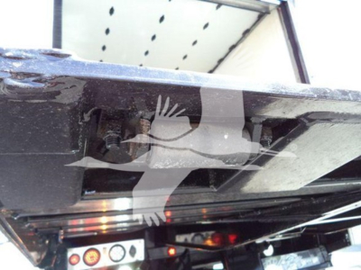 Mack MD6 rollback truck undercarriage showing hydraulic lines and chassis with warning decals and metal frame, VIN partially visible in catalog photo.