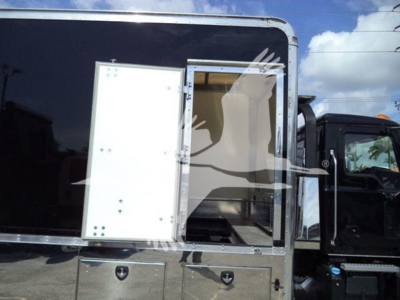 Mack MD6 rollback truck side view showing side entry door and metal storage compartments