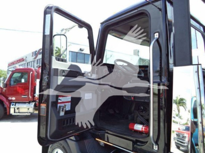Mack MD6 truck cab with open doors showing interior and empty cargo area.