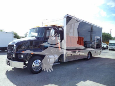 MD6 dump truck with a large black cab and a long silver/gray module body, side view showing chrome wheels and side mirrors.