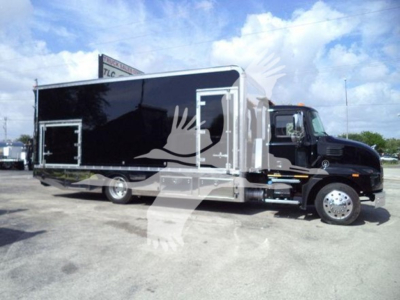 Truck body showing Mack MD6 rollback with black box body and chrome accents, cab with black paint, side door, and dual rear wheels.