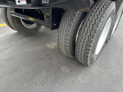 Jet Side Dump trailer wheel area showing dual rear tires and undercarriage components.
