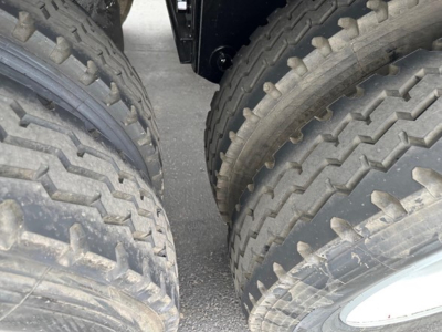 Jet side dump trailer tires close-up view showing dual-wheel configuration and tread pattern.