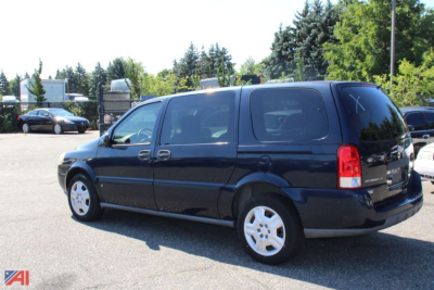 2007 Chevrolet Uplander minivan in dark blue, side/rear view parked in lot.