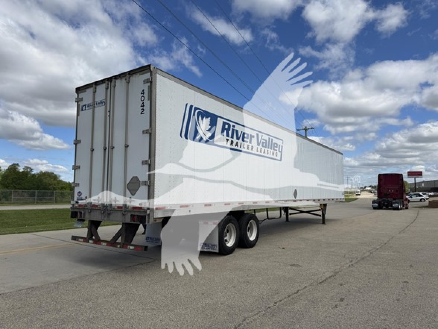 Trailer showing River Valley Trailer Leasing logo on a large white utility trailer with dual rear wheels and a number 4042 on the back door.