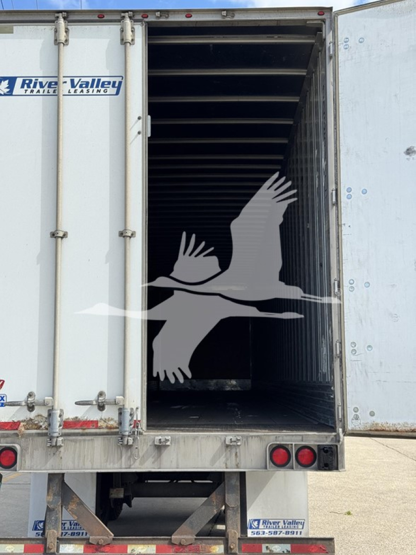 Trailer rear interior showing empty cargo space with rails, open doors, and River Valley branding on doors and bumper; vehicle is a 2014 Utility 4000Dx trailer.